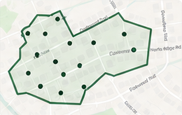 Pale street-map panel with a dark green outlined service route and location dots.