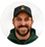 Small circular profile photograph of a smiling bearded man wearing a dark cap.