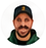 Circular headshot of a bearded man wearing a dark cap and dark shirt.