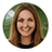 Circular headshot of Sarah Johnson, smiling woman with long light brown hair.