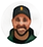 Circular staff profile photo of a bearded man in a dark cap and dark top.